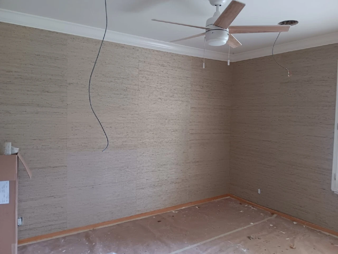 Careful wallpaper application on restored plaster walls in a Victorian home